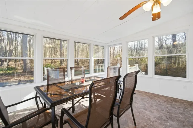 a view of a dining room with furniture large windows and wooden floor