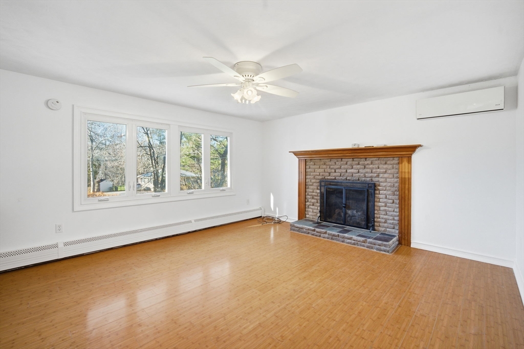 7 Fuller Road Sutton, MA 01590 - Photo 5 of 29 an empty room with windows and fireplace