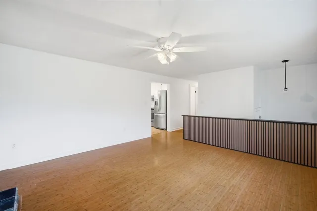 a view of an empty room with a ceiling fan