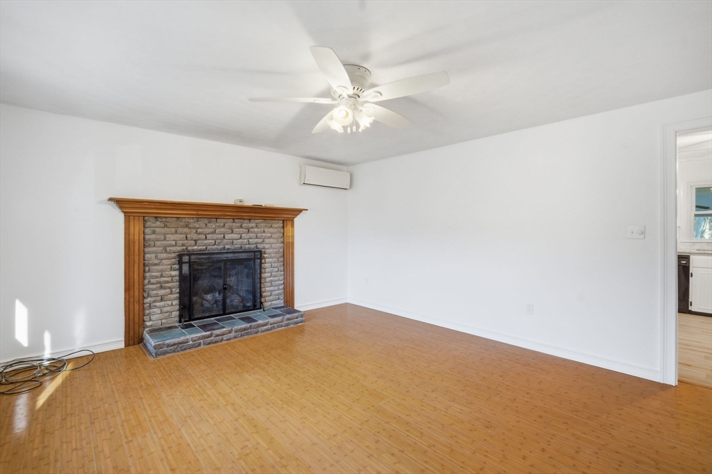 7 Fuller Road Sutton, MA 01590 - Photo 8 of 29 an empty room with fan and fireplace