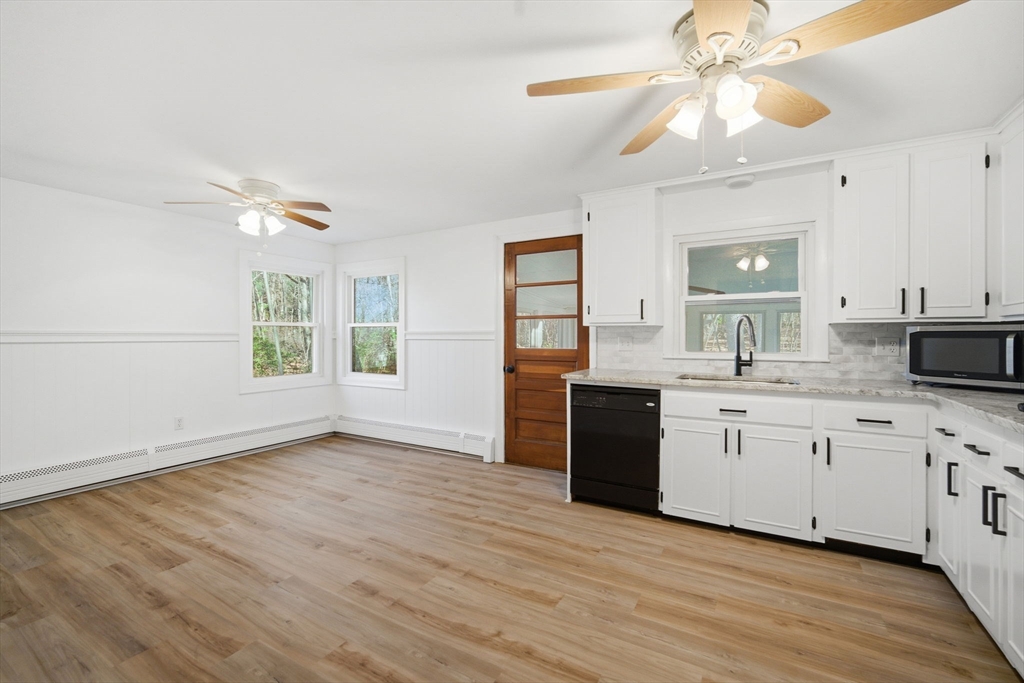 7 Fuller Road Sutton, MA 01590 - Photo 9 of 29 a kitchen with granite countertop a stove a sink and a microwave