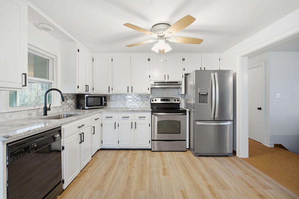 7 Fuller Road Sutton, MA 01590 - Photo 10 of 29 a kitchen with cabinets stainless steel appliances and a window