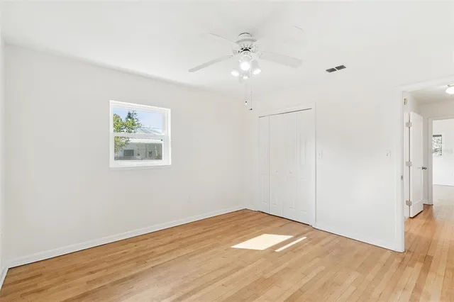 a view of a room with wooden floor