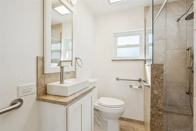 a bathroom with a shower and a window