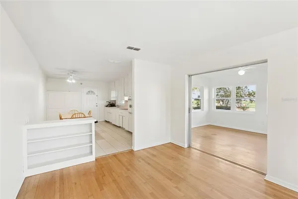 a kitchen with stainless steel appliances granite countertop a sink a stove a dining table and chairs