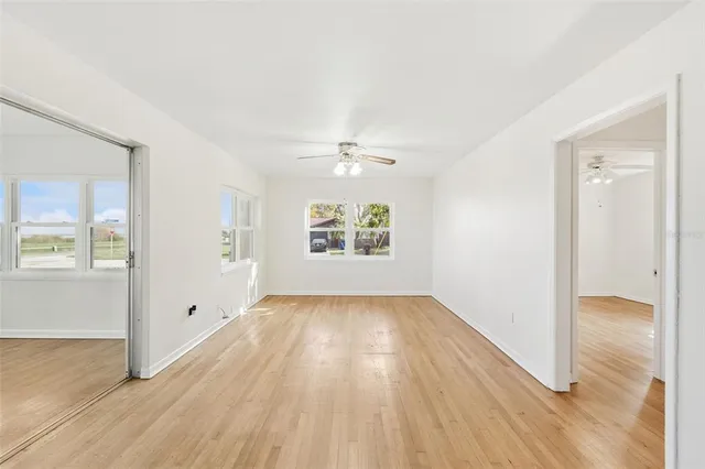 wooden floor in an empty room with a window