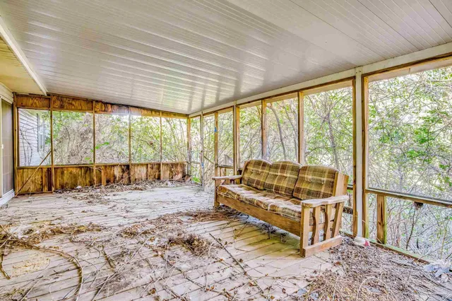 a view of a balcony with wooden floor and fence