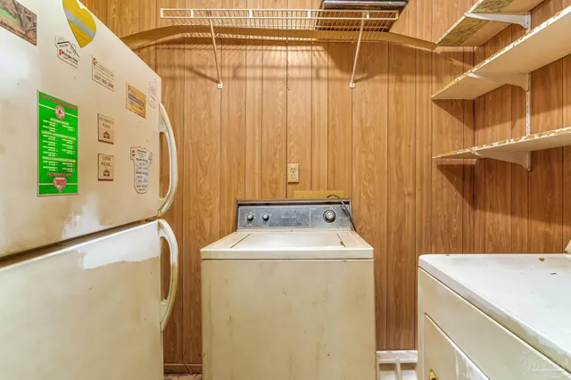 an empty room with chandelier fan