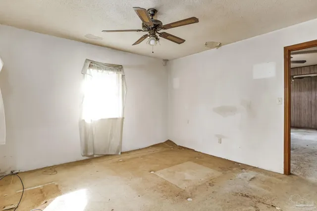 a view of room with window and ceiling fan