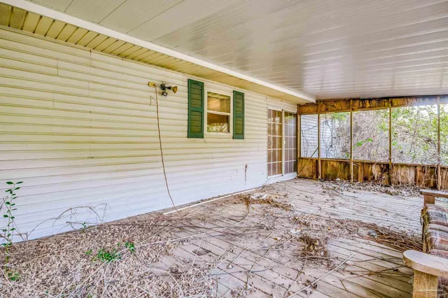 a view of a balcony with wooden floor and iron stairs