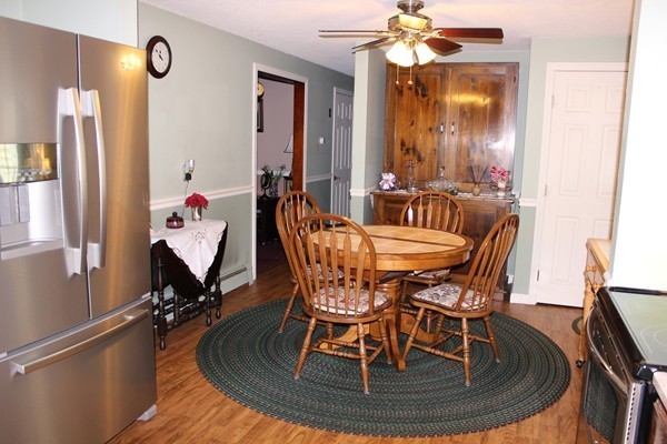 147 S Road Templeton, MA 01468 - Photo 6 of 21 a dining room with furniture a chandelier and wooden floor