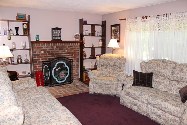 147 S Road Templeton, MA 01468 - Photo 10 of 21 a living room with furniture a flat screen tv and a fireplace