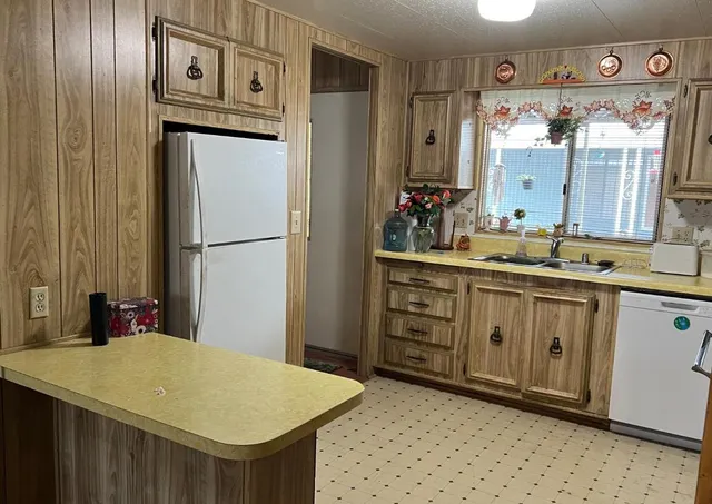 a kitchen with stainless steel appliances a refrigerator and cabinets