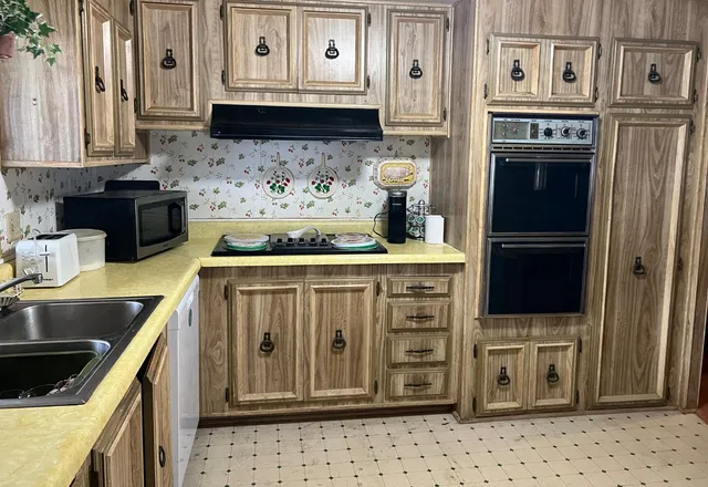 a kitchen with stainless steel appliances granite countertop a stove and a refrigerator