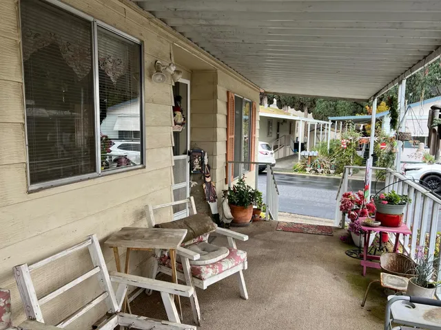 a backyard of a house with outdoor seating