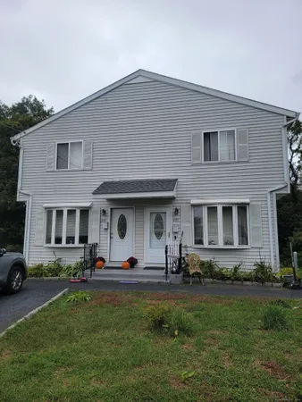 a front view of house with yard and outdoor seating