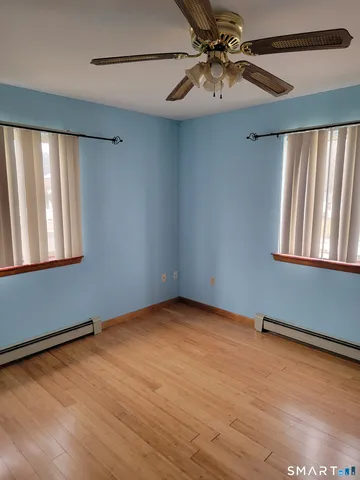 a view of a room with a ceiling fan and a window