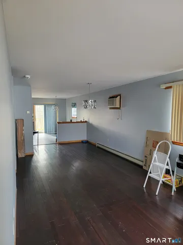a view of a workspace with furniture and wooden floor