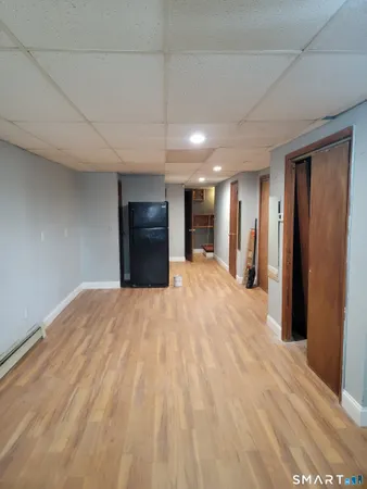 a large bedroom with a bed and a mirror