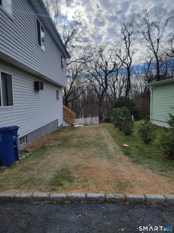 a view of a house with wooden deck