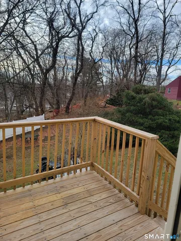a view of wooden balcony with furniture