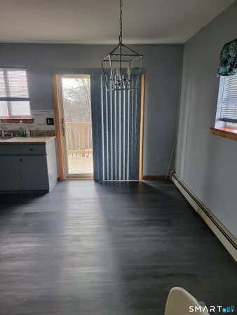 a view of kitchen and hall with wooden floor
