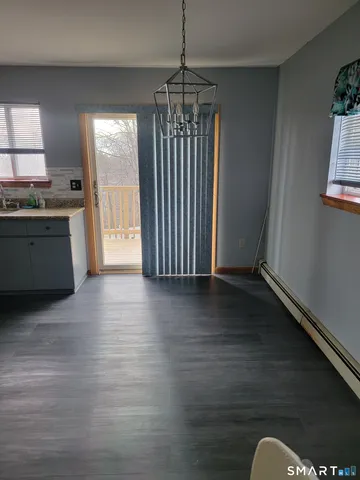 a view of kitchen and hall with wooden floor