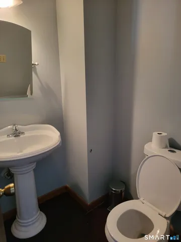a bathroom with a sink toilet and a mirror