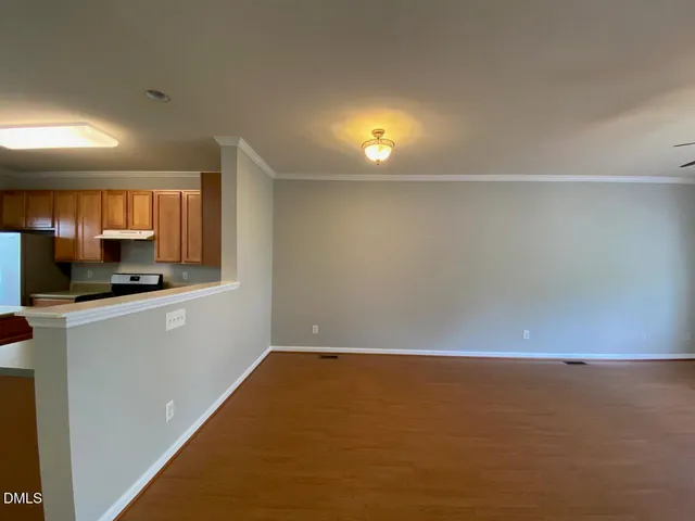 a view of room with microwave and cabinets