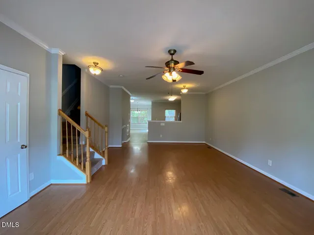 a view of livingroom with stairs and wooden floor