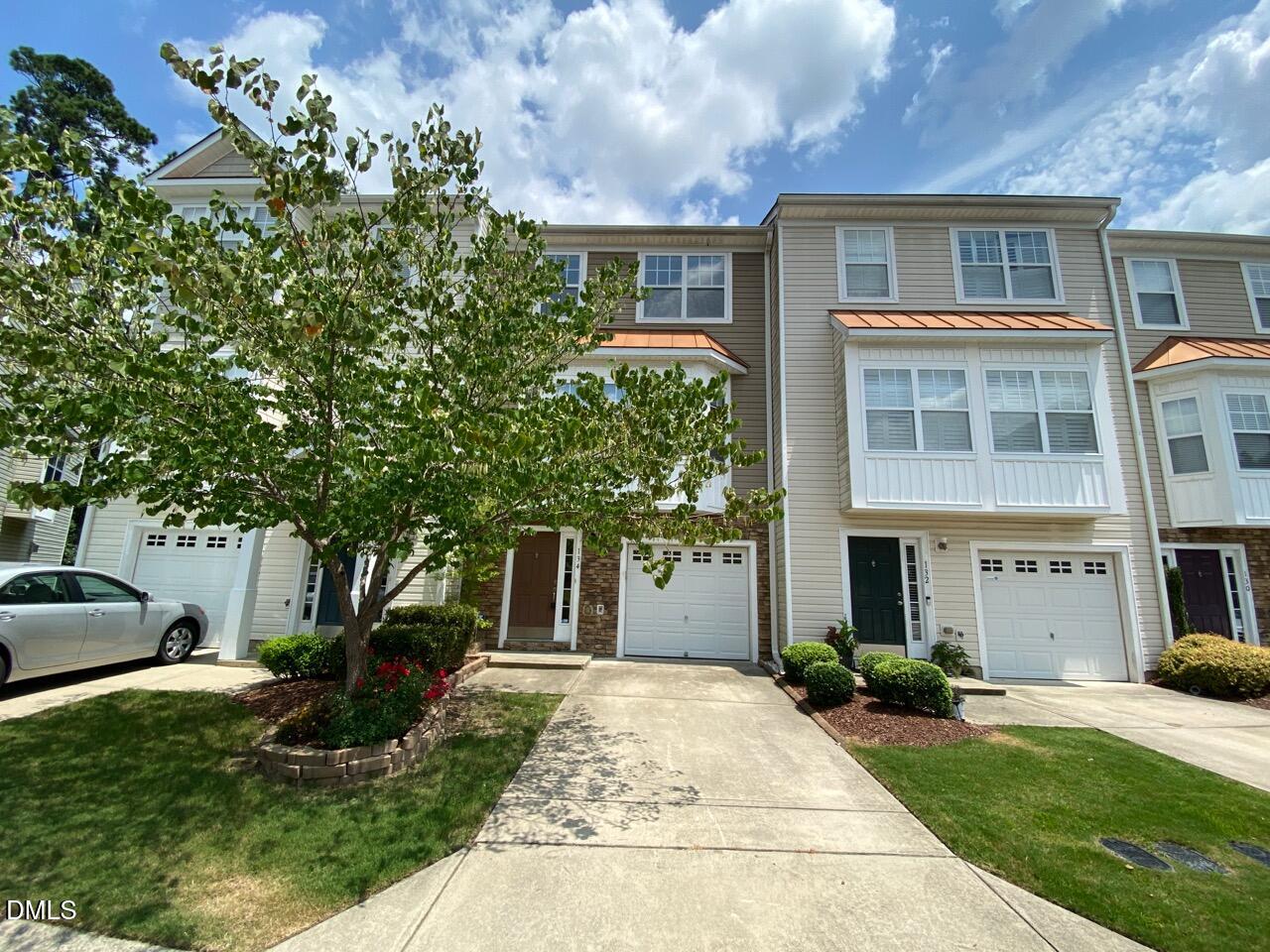 134 Darley Dale Loop Apex, NC 27502 - Photo 2 of 23 a front view of a house with garden