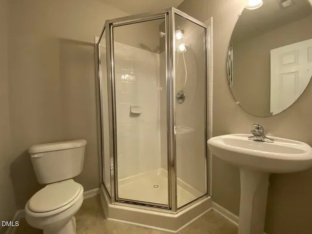 a bathroom with a toilet sink and shower