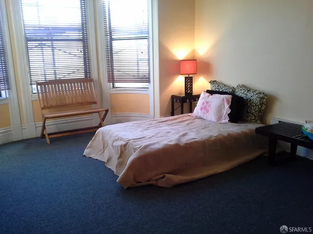 a bedroom with a bed and a window