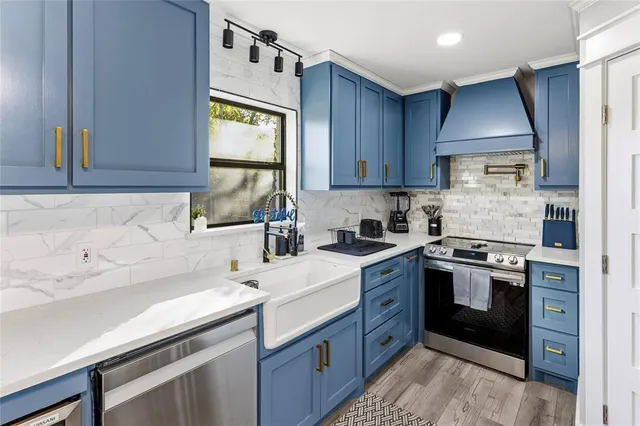 a kitchen with a sink stove and cabinets