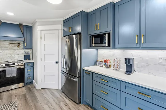 a kitchen with stainless steel appliances and wooden cabinets