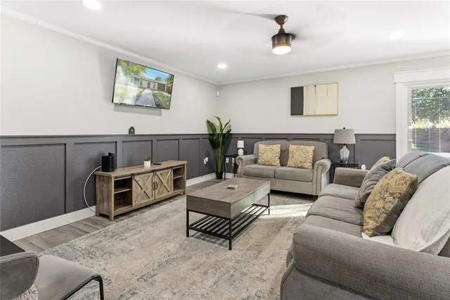 a living room with furniture and wooden floor