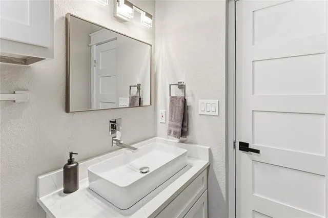a bathroom with a sink and a mirror