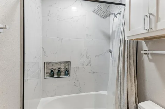 a bathroom with a shower and a toilet