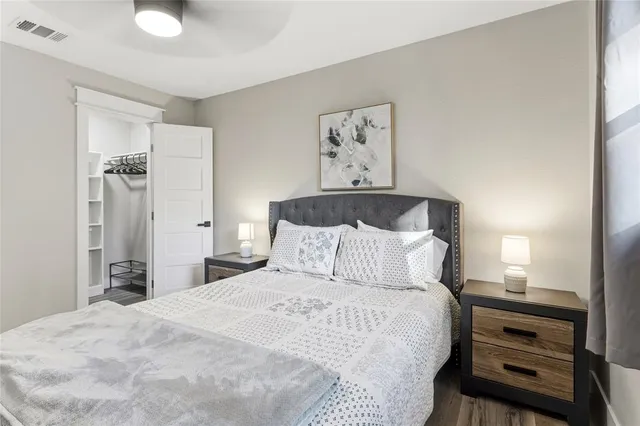 a bedroom with a bed and a chandelier