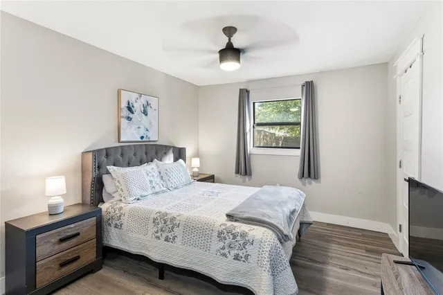 a bedroom with a bed and a tv on the dresser
