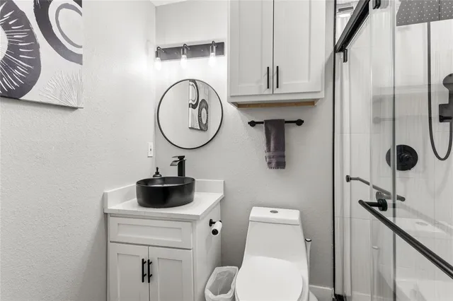 a bathroom with a toilet a sink and a mirror