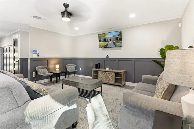 a living room with furniture and a wooden floor