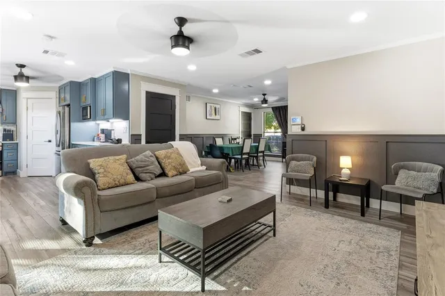 a living room with furniture and a chandelier