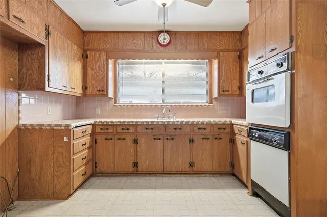 a kitchen with granite countertop a sink and a stove