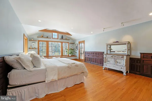 a bedroom with a bed a table and chair