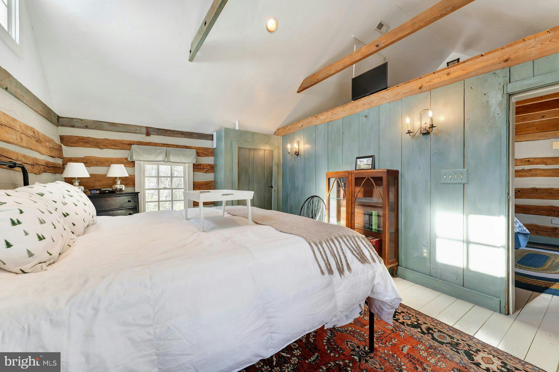 43470 Evans Pond Road Leesburg, VA 20176 - Photo 58 of 114 a spacious bedroom with a bed and a large window with the garden view