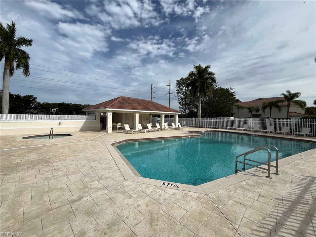 884 Hampton Circle, Unit 159 Naples, FL 34105 - Photo 22 of 28 a view of a swimming pool with a yard