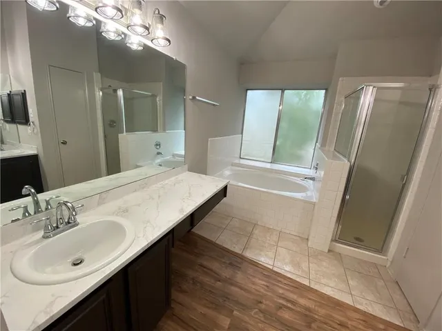 a bathroom with a sink a mirror and a shower