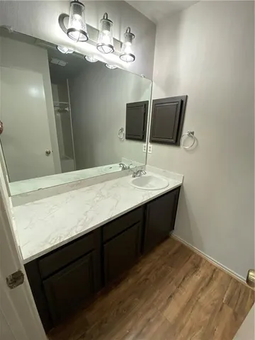 a bathroom with a sink vanity and a mirror