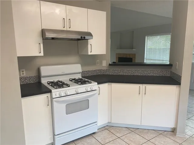 a stove top oven sitting inside of a kitchen